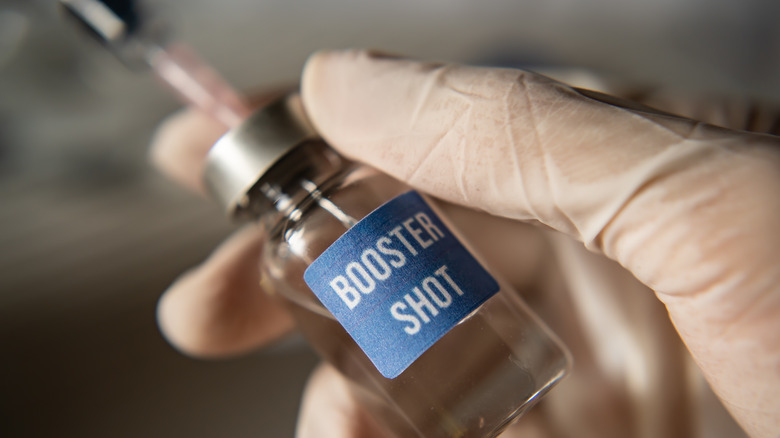 COVID-19 booster shot vaccine with needle in the vial