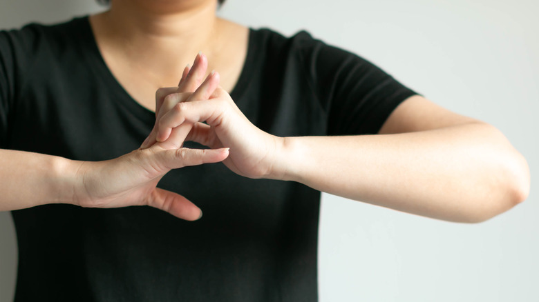 Close up of woman cracking her knuckles