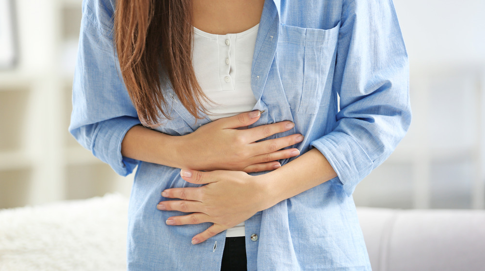 Woman clutching stomach