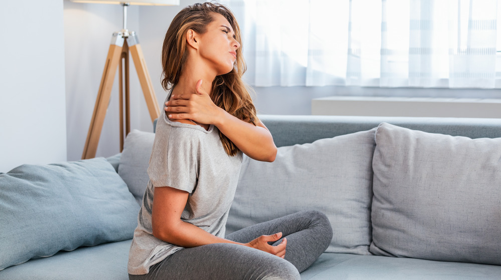 Woman clutching sore neck