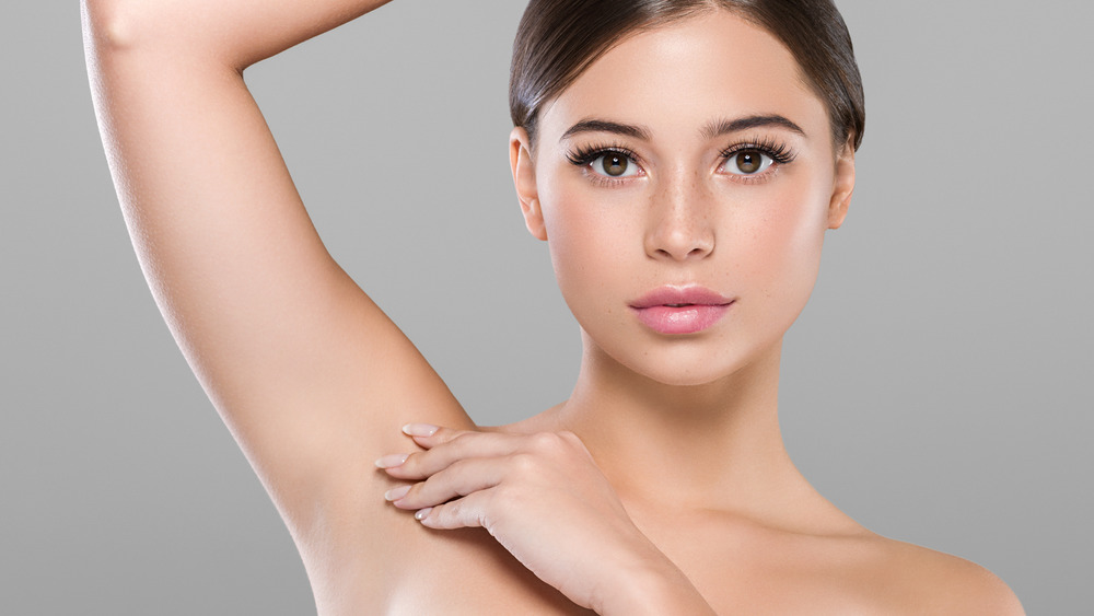 woman with one arm raised up