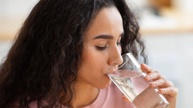 brunette woman drinking water