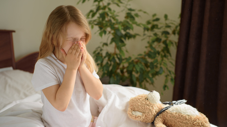 Little girl sneezing