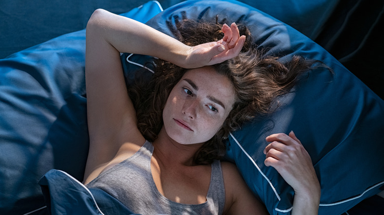 insomniac woman laying in bed