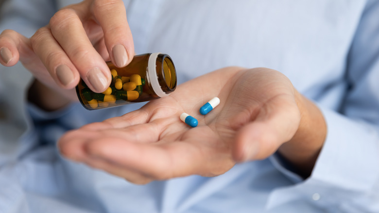 woman holding pill bottle