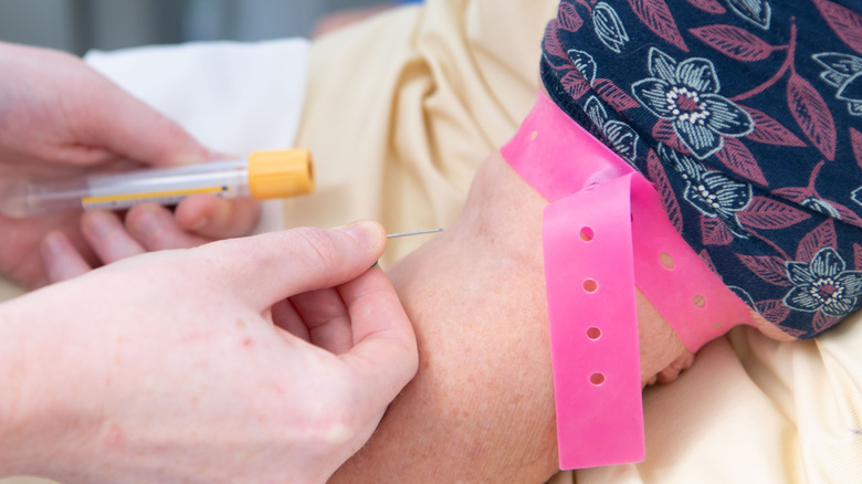 Doctor prepares to draw patient's blood