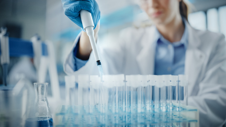 Lab scientist with test tubes