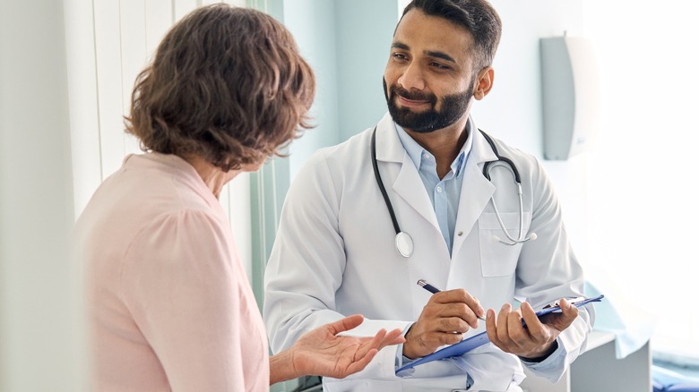 Doctor speaking with woman