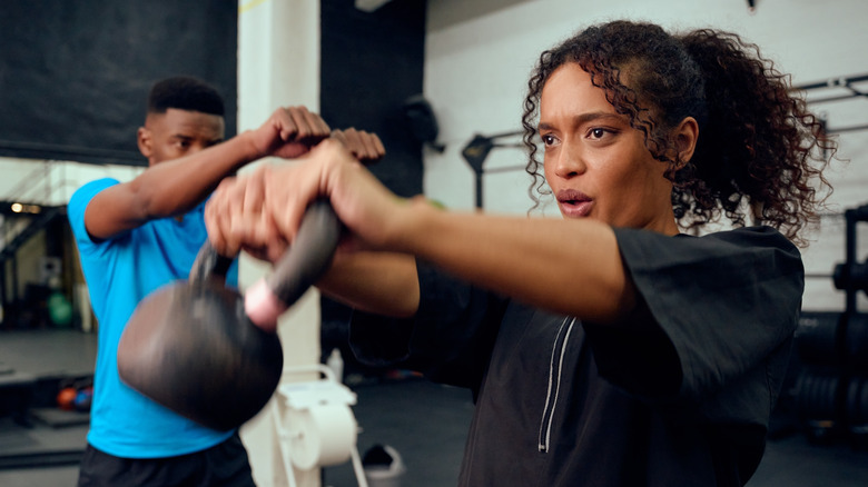woman working out with kettlebell