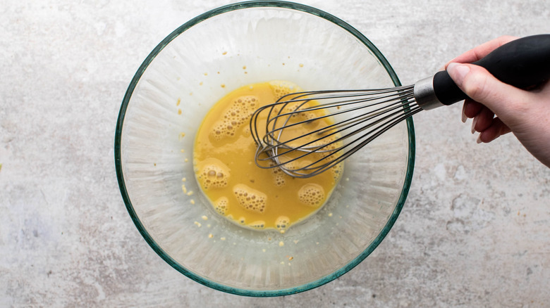 whisking caesar salad dressing
