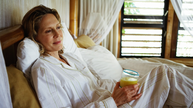 woman sitting upright in bed
