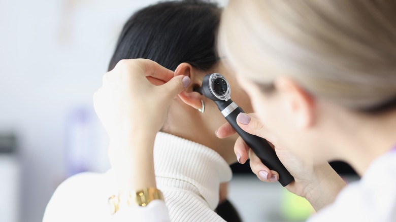 doctor checking patient's ear