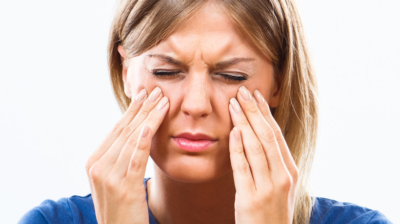 female pressing face in pain