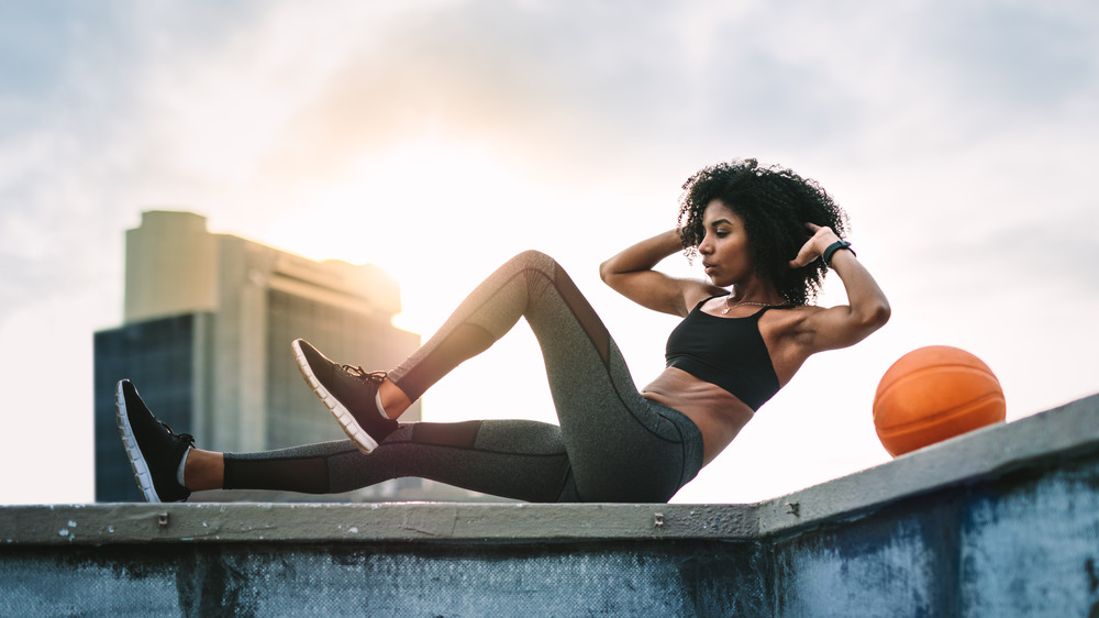 woman doing crunches outside