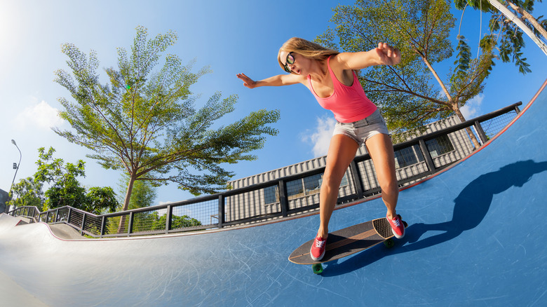 Young woman skateboarding on a ramp 