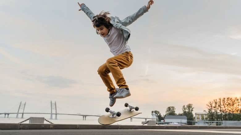 Young kid attempting a flip on a skateboard 