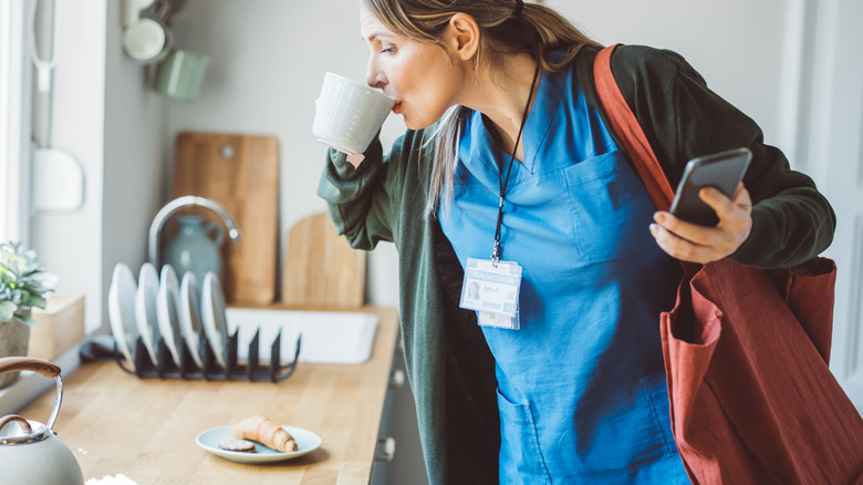 Doctor sipping coffee as they leave the house