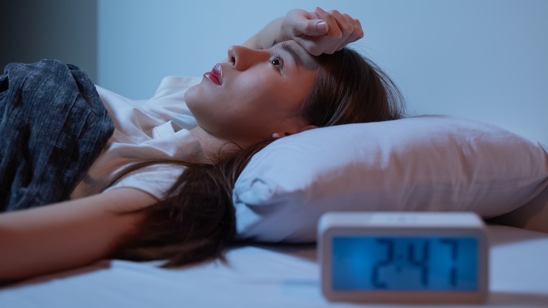Woman lying awake in bed