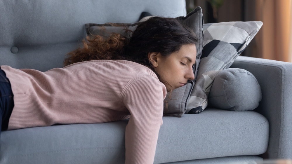 Young woman napping on sofa