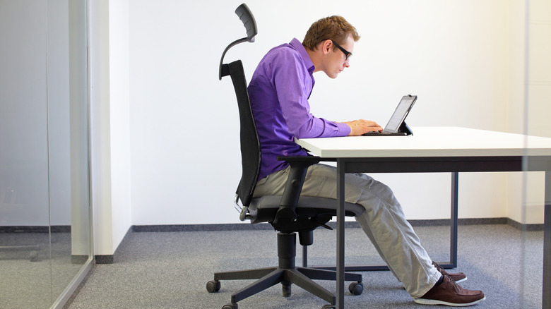 man slouching at his desk