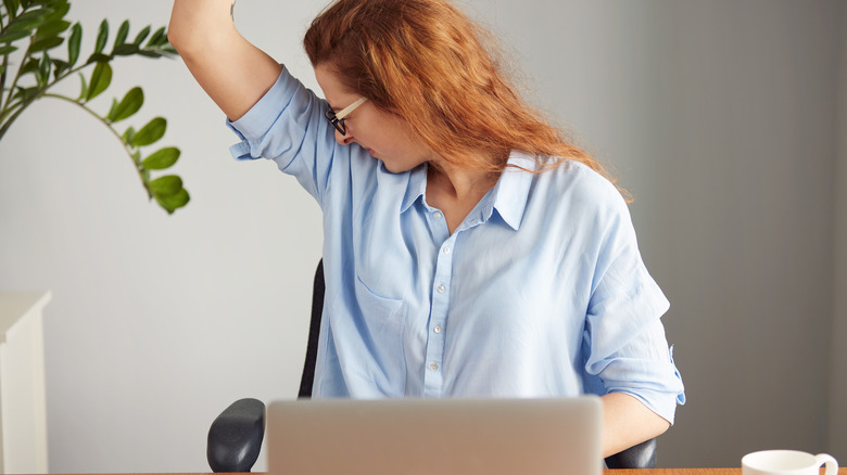 woman smelling her underarm