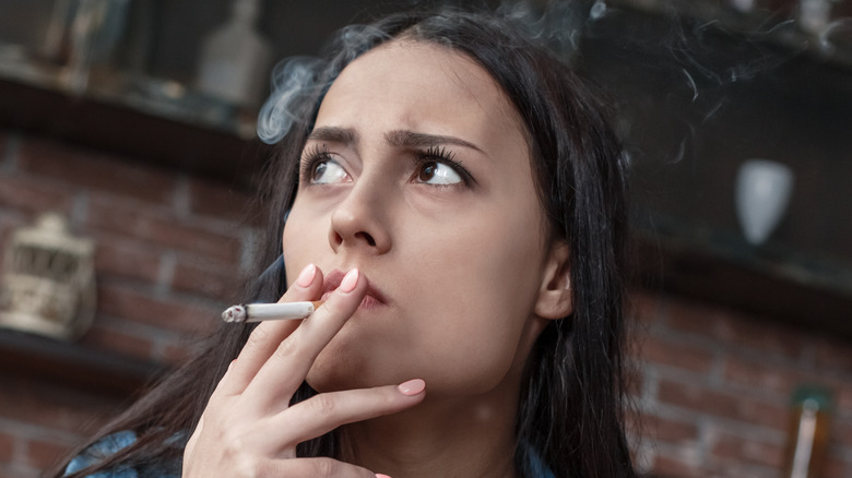 Concerned woman smoking a cigarette