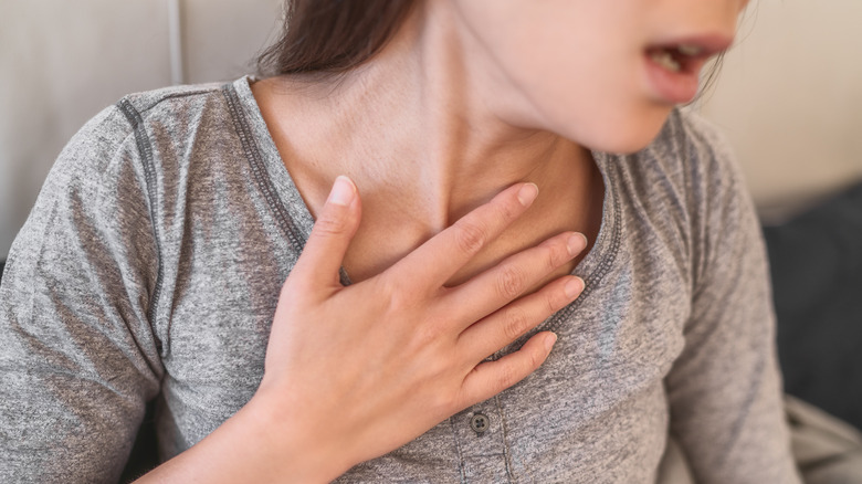 woman holding chest