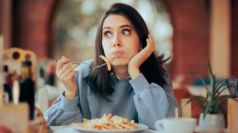 Woman eating french fries