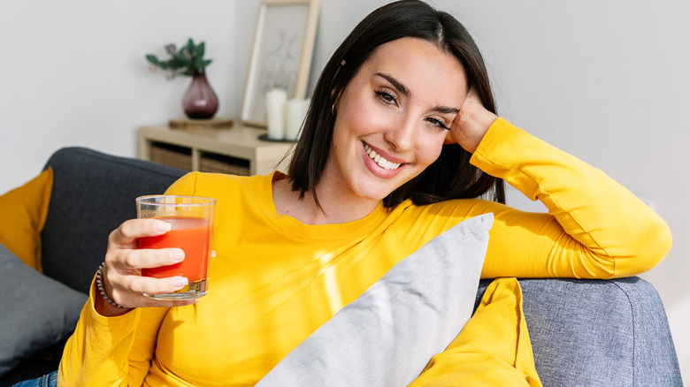 woman holding glass of V8