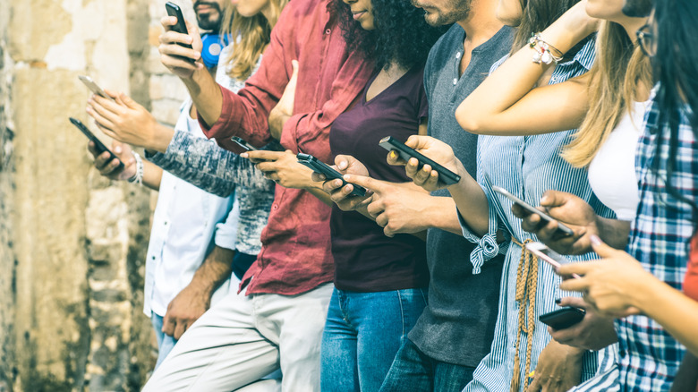 line of people on cell phones