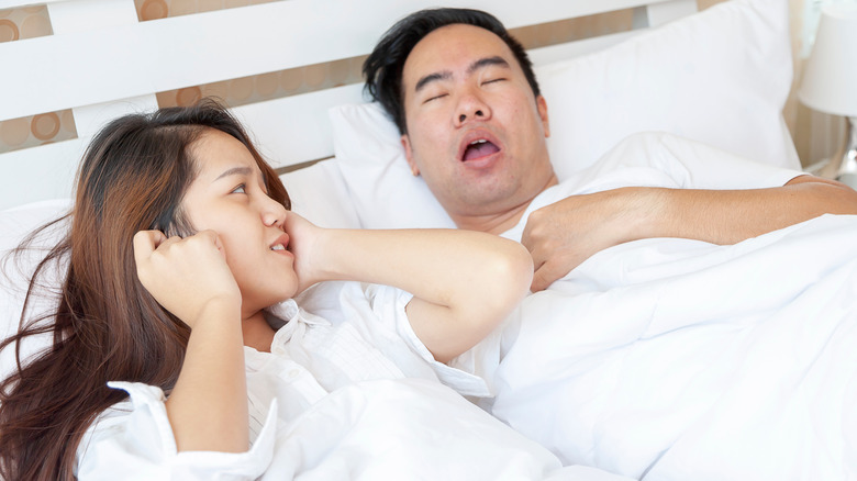 man snoring in bed