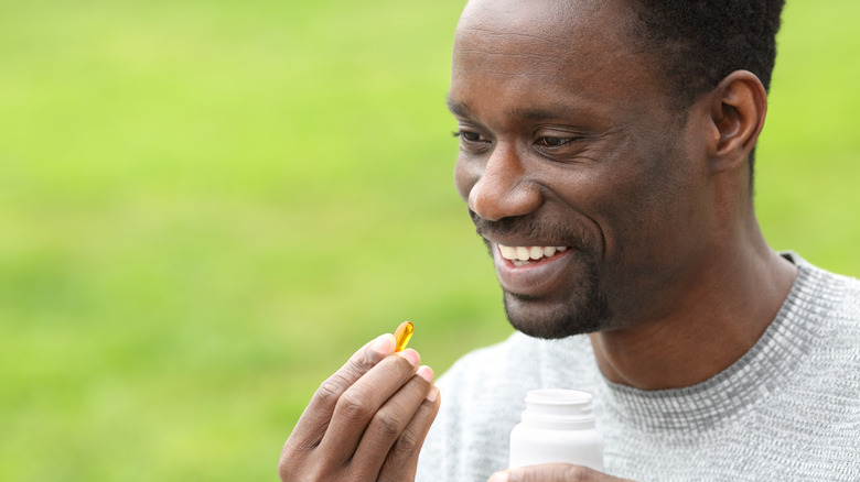 A man takes a vitamin