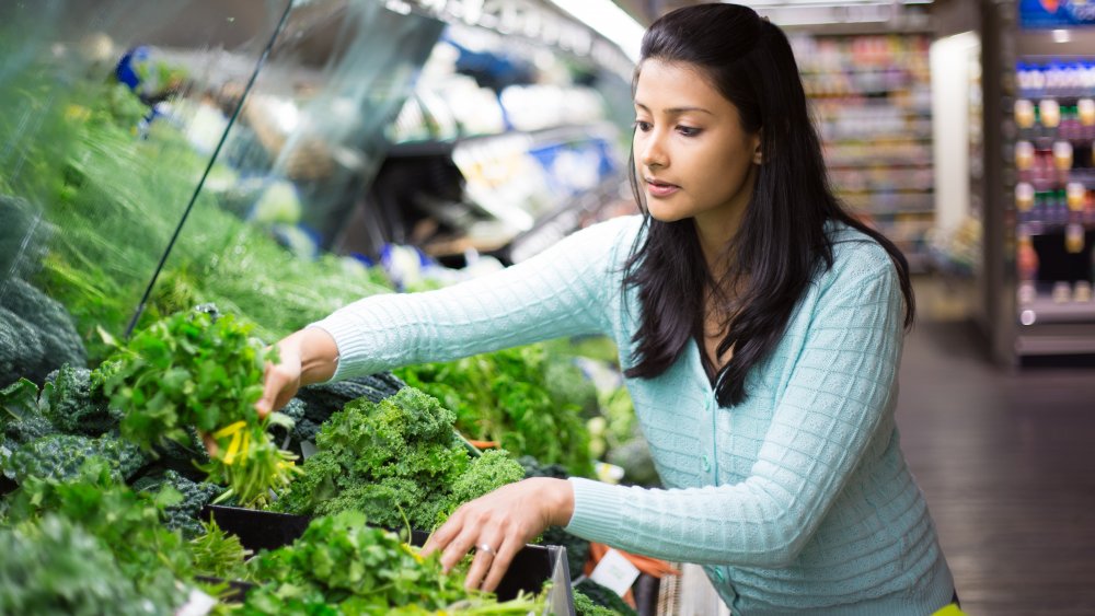 Woman choosing greens
