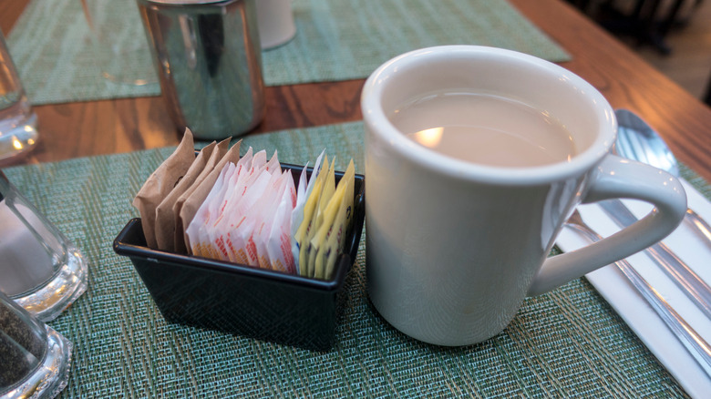 sugar packets and coffee cup