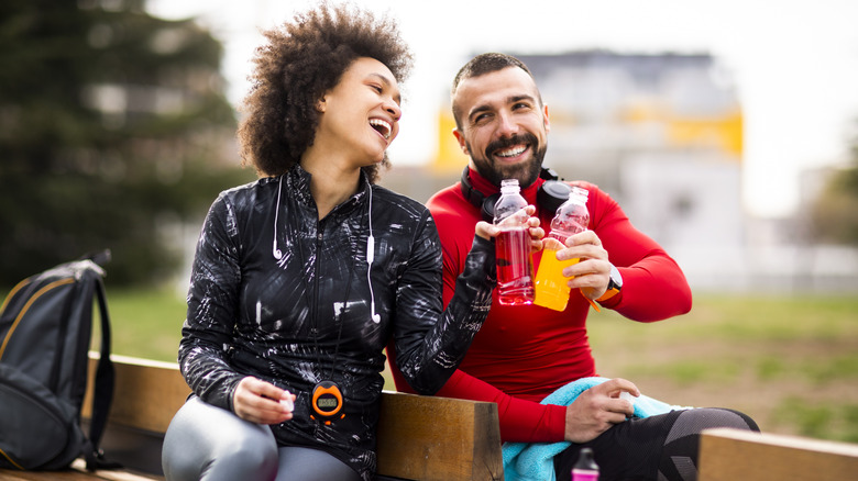runners toasting with sports drinks