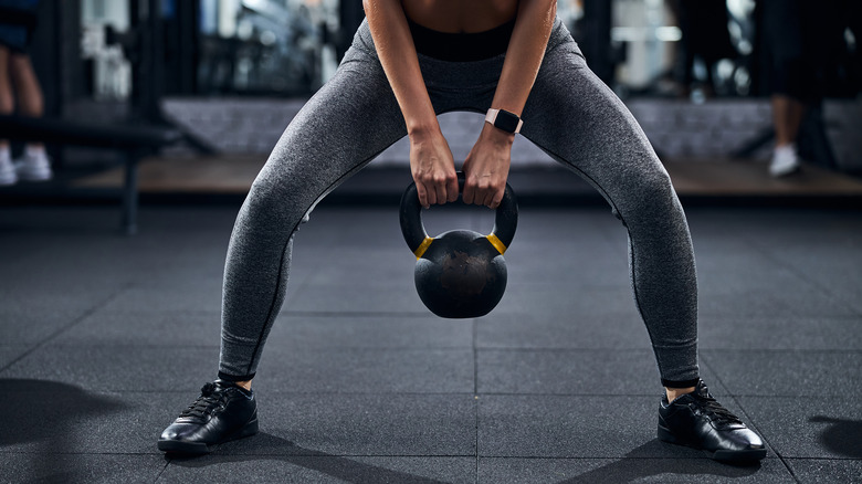 A woman does sumo squats