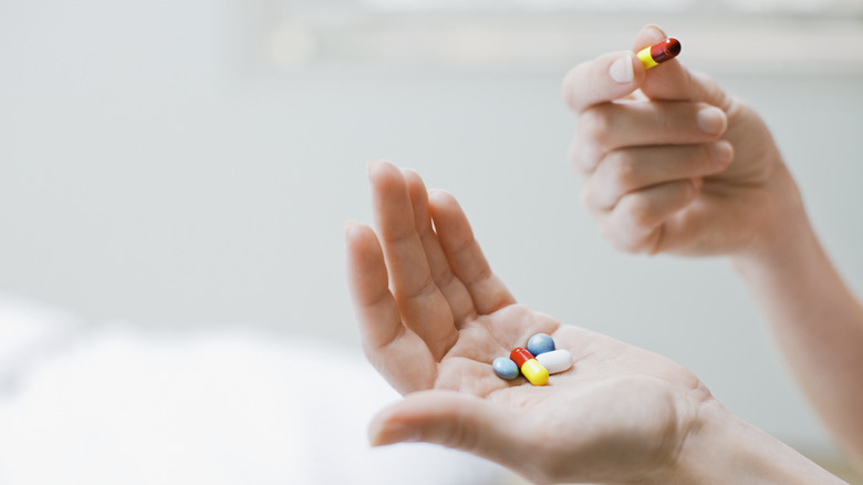 person holding pills