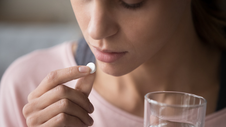 woman taking pill