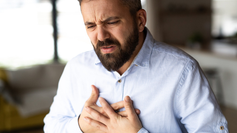 Man experiencing chest pains as part of a heart attack