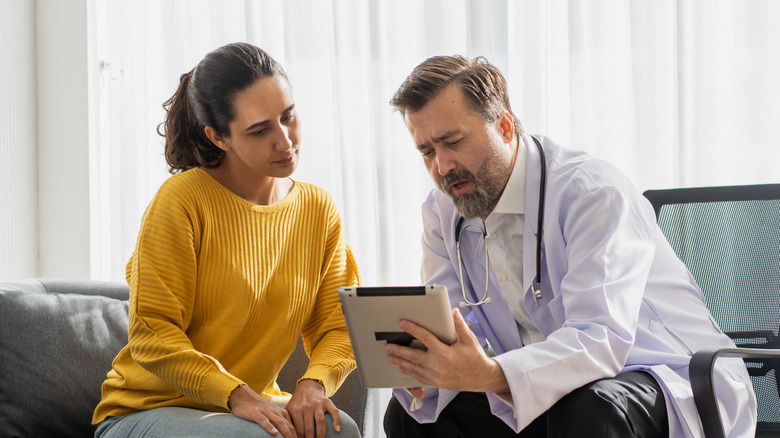 A doctor is discussing with his female patient results of tests