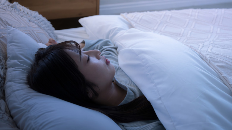 A woman sleeping in bed