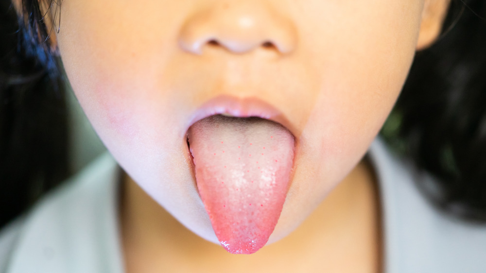 Close up of a little girl sticking out her tongue 