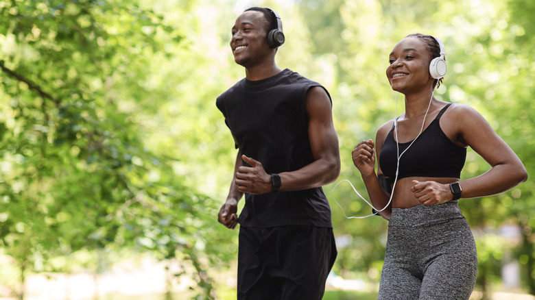 happy african american couple jogging
