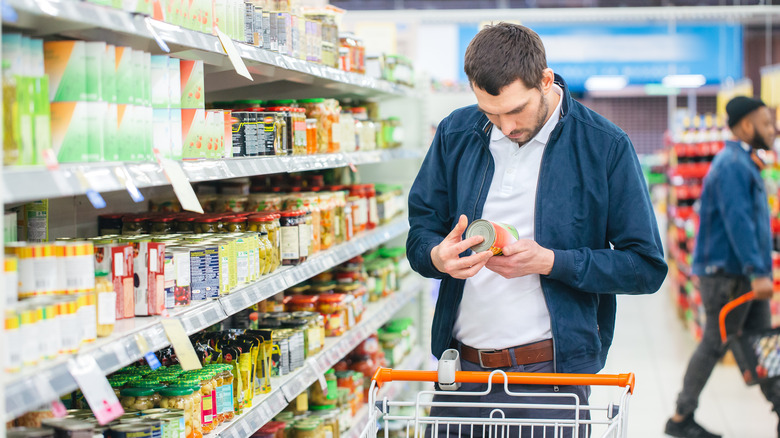 Man looking at a can