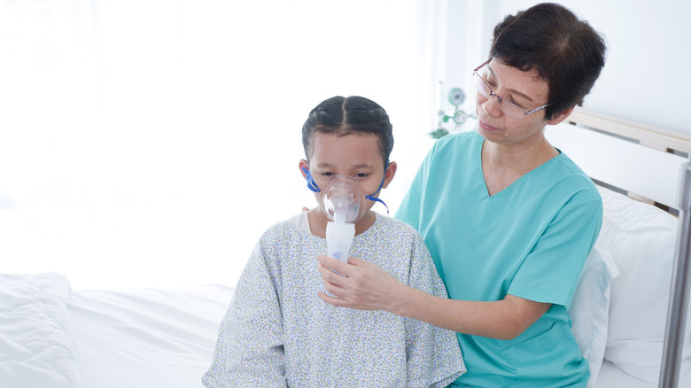 Girl with oxygen mask on face