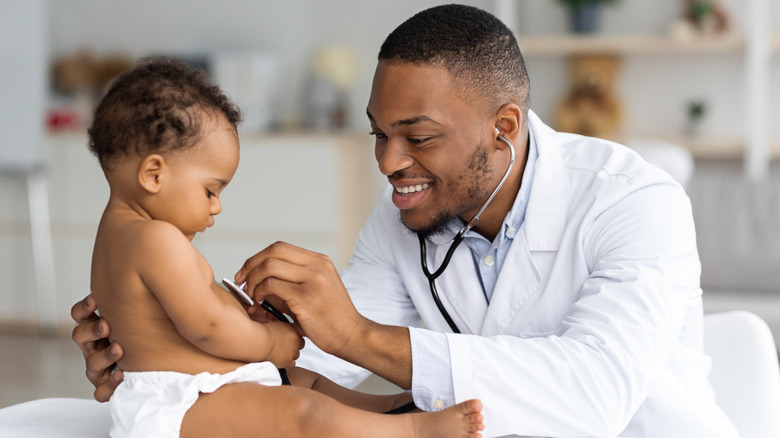 Doctor examining baby