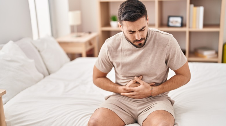 man holding his upset stomach