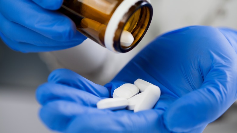 doctor pouring medication into his hand