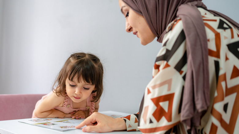 parent working with her child at home