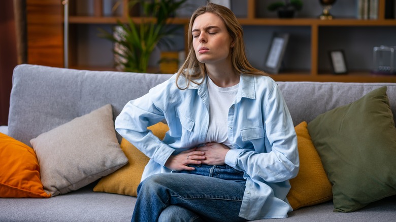 Woman holding stomach